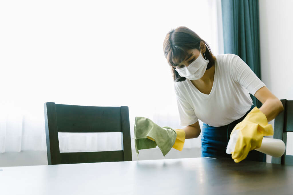 an Indonesia helper cleaning the table